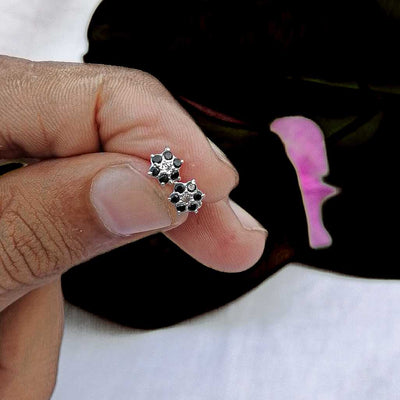 5 mm black floral stud on lobe piercing

