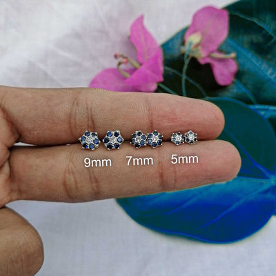 5mm, 7mm and 9mm 3-pair flower stud set flat lay on hand