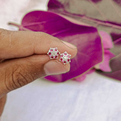 three pink flower stud earrings flat lay

