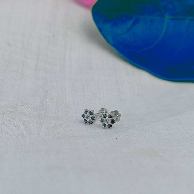 Blue flower stud worn on helix piercing 

