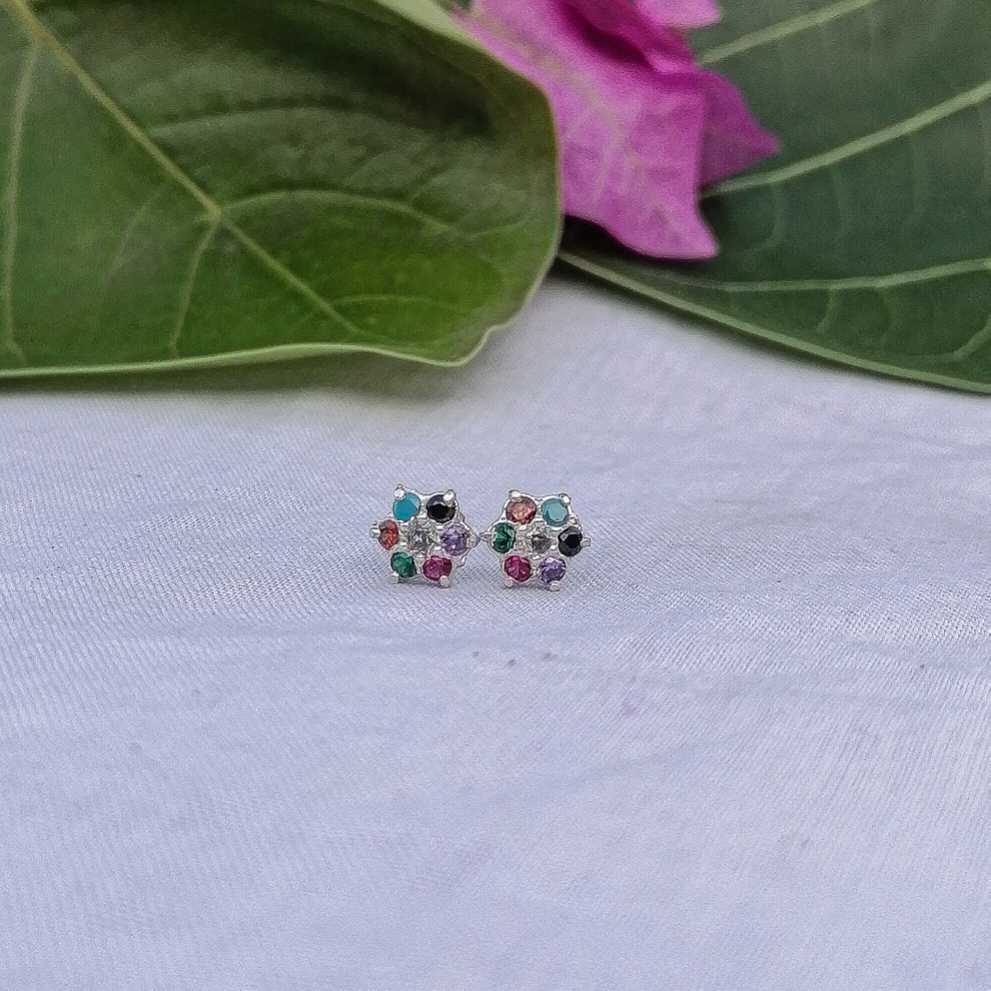 Flat lay of 3 colorful flower earrings silver base with skin safe material