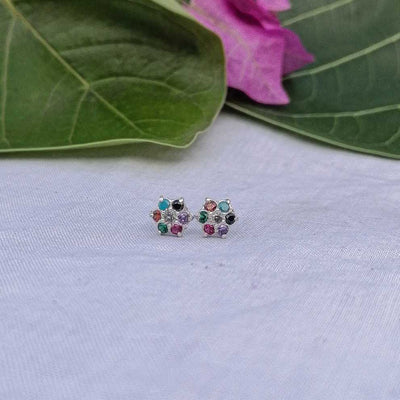 Flat lay of 3 colorful flower earrings silver base with skin safe material